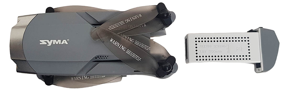 Složený SYMA X30 shora v detailu s akumulátorem... Složený SYMA X30 shora v detailu s akumulátorem...